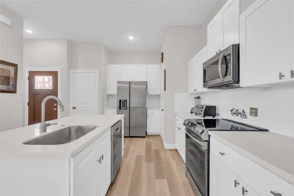 a kitchen with a sink a table and chairs