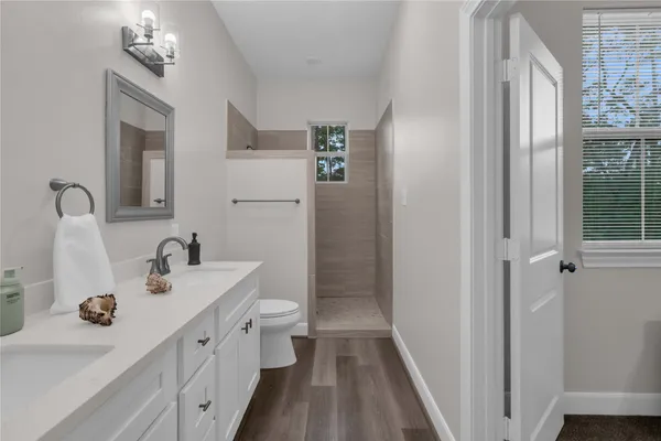 a bathroom with a toilet sink and mirror