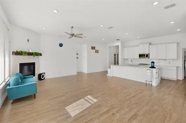 a living room with kitchen island furniture and a fireplace