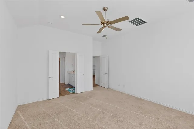 a view of a room with a ceiling fan