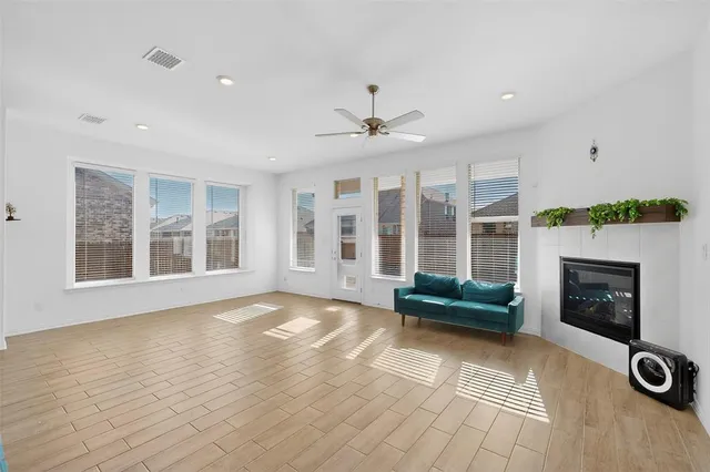 a view of an empty room with glass door and windows