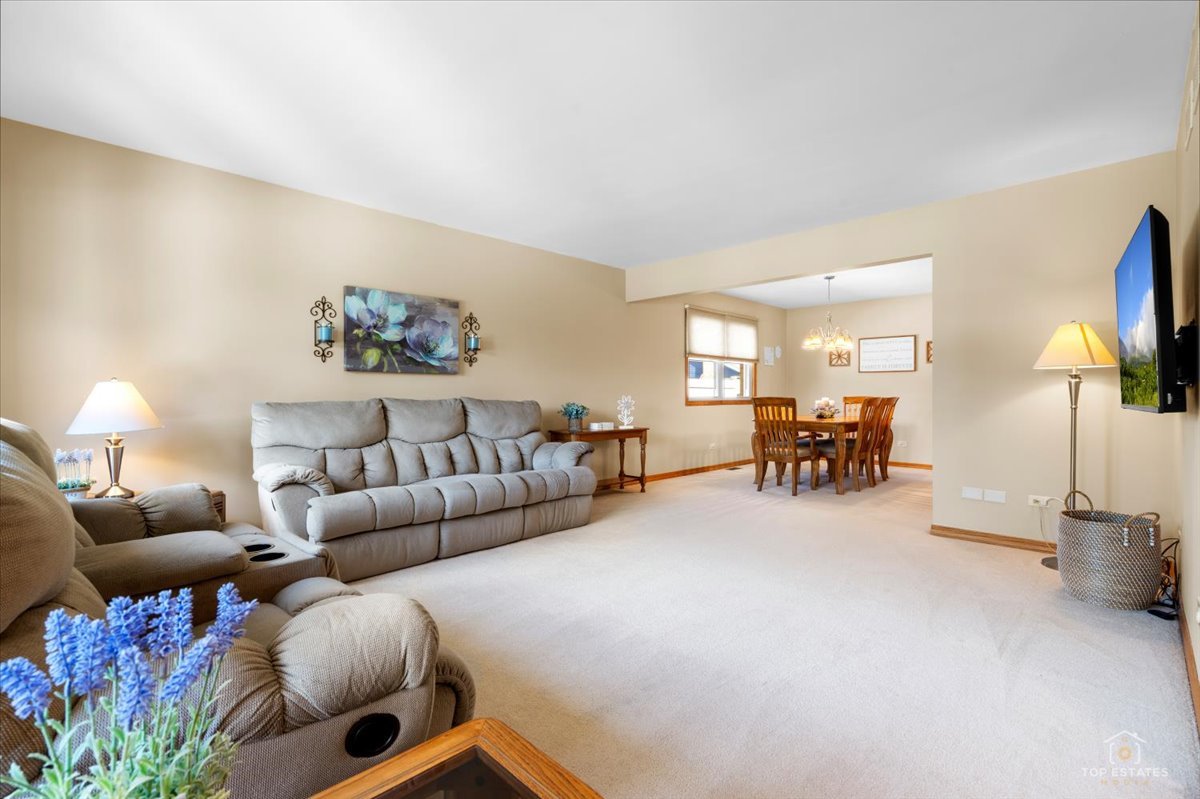 8124 Nottingham Road Tinley Park, IL 60477 - Photo 4 of 33 a living room with furniture and a flat screen tv with wooden floor