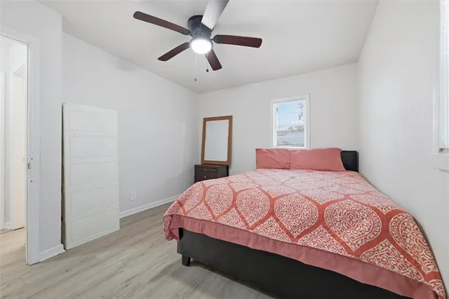 a bedroom with a bed and wooden floor