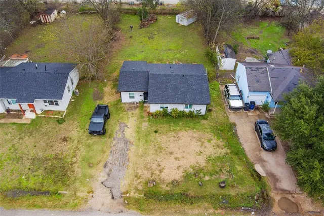 an aerial view of a house with a yard