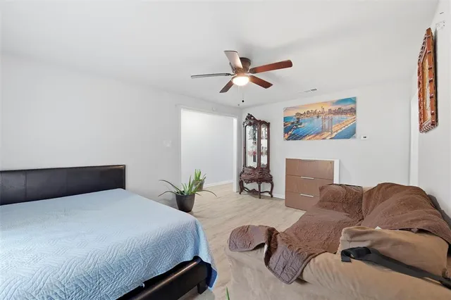 a bedroom with a bed couch and window