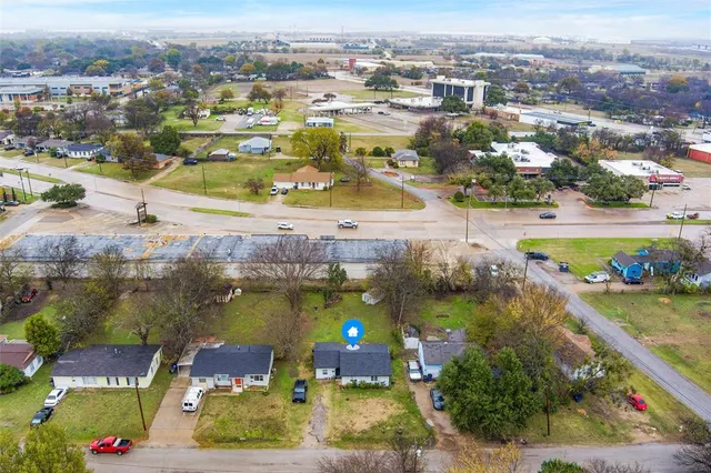 an aerial view of residential houses with outdoor space