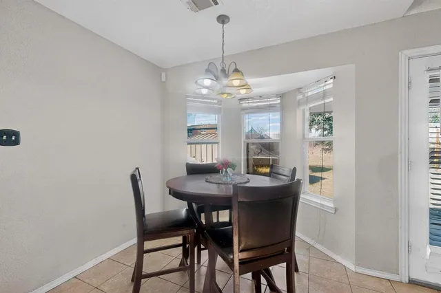 a dining room with furniture and window