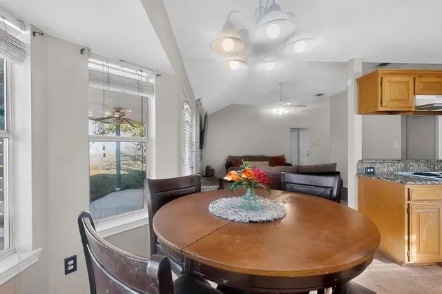 a dining room with furniture and wooden floor