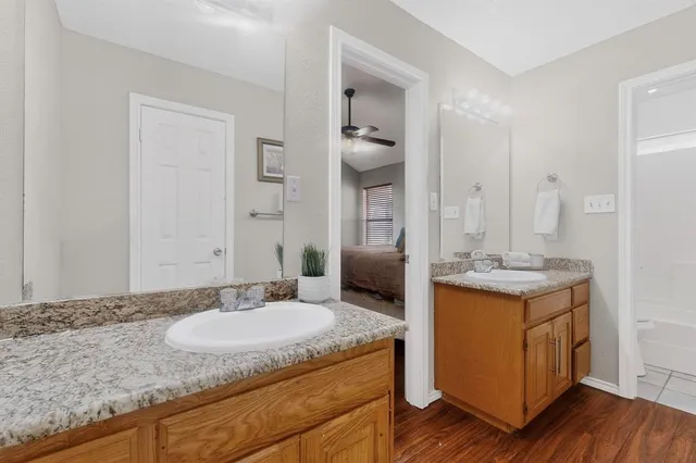a bathroom with a granite countertop sink and a mirror