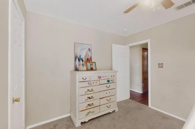 a bathroom with a granite countertop sink and a toilet