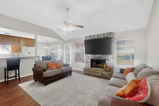 a living room with furniture a fireplace and a flat screen tv