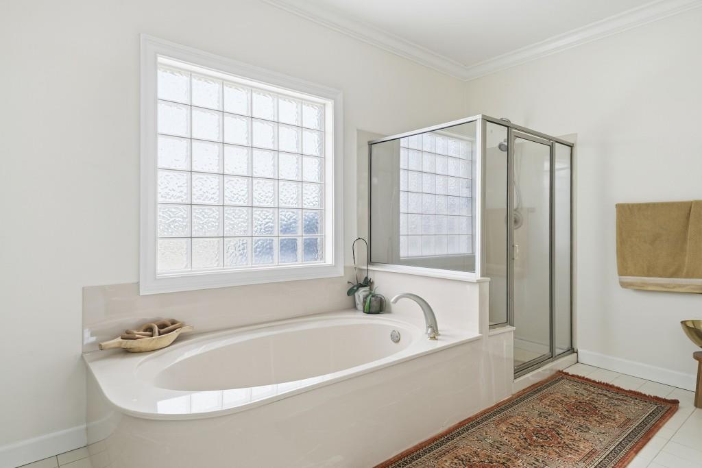 398 South 6th St Extension Milner, GA 30257 - Photo 12 of 30 a white bath tub sitting next to a window