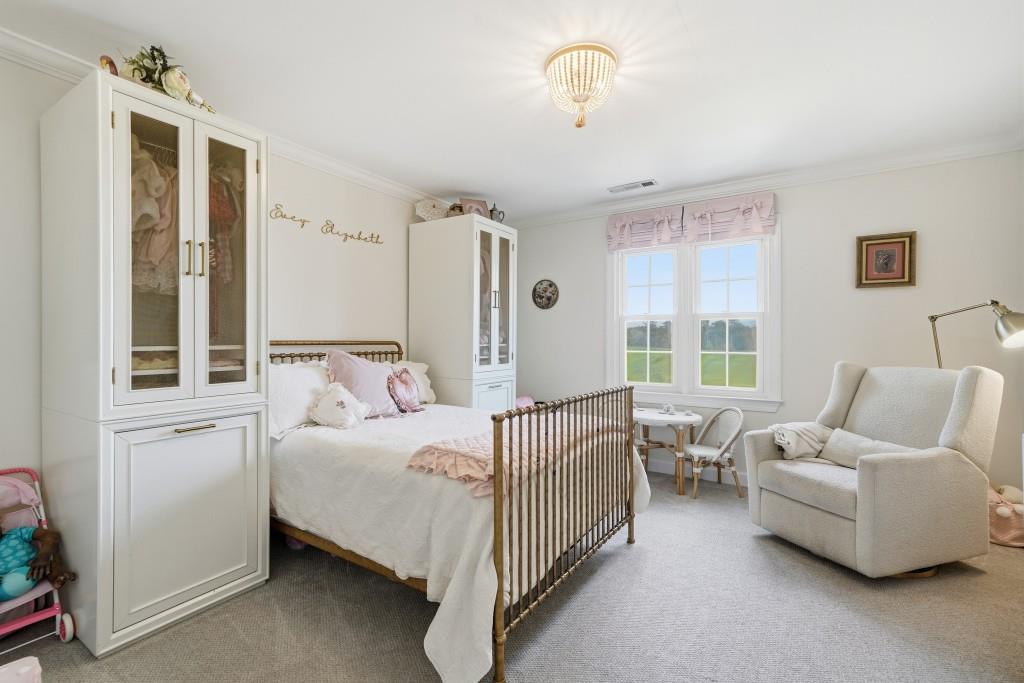 398 South 6th St Extension Milner, GA 30257 - Photo 13 of 30 a bedroom with bed and a window