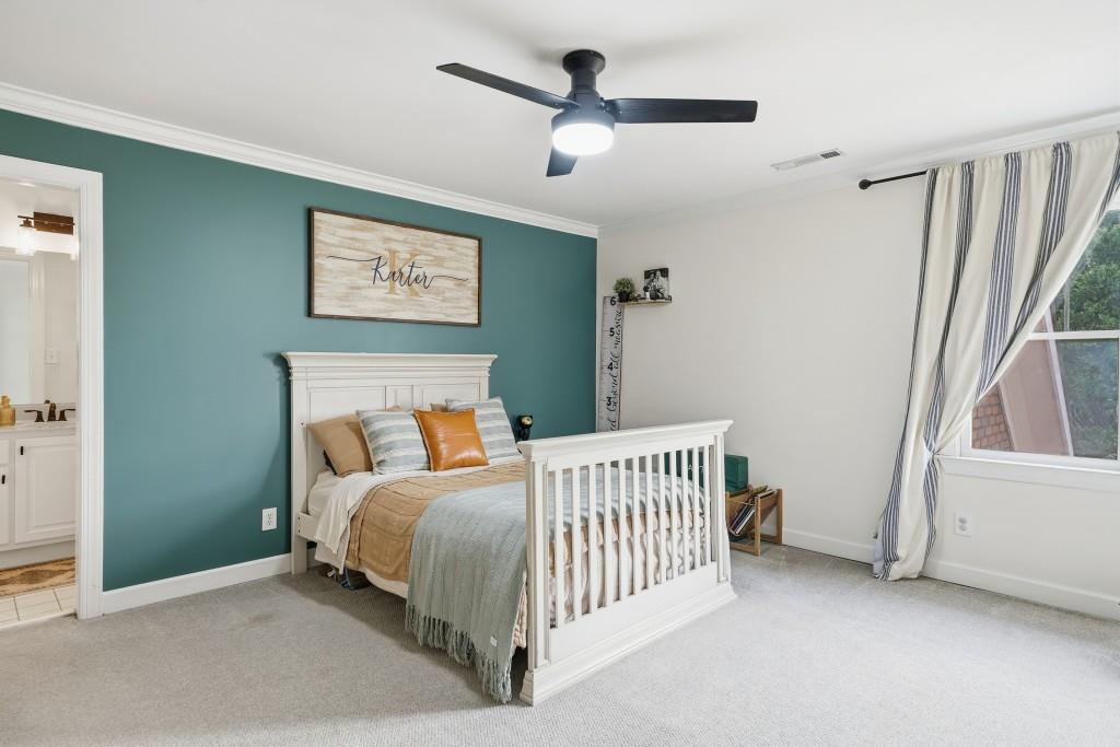 398 South 6th St Extension Milner, GA 30257 - Photo 14 of 30 a bedroom with a bed and a window