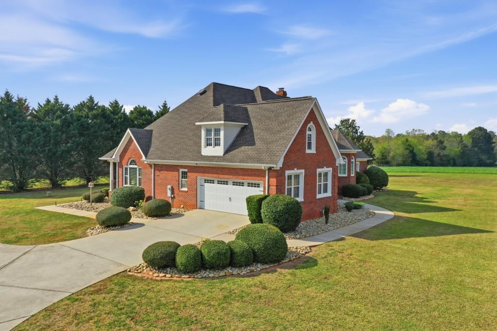 398 South 6th St Extension Milner, GA 30257 - Photo 16 of 30 a front view of a house with garden