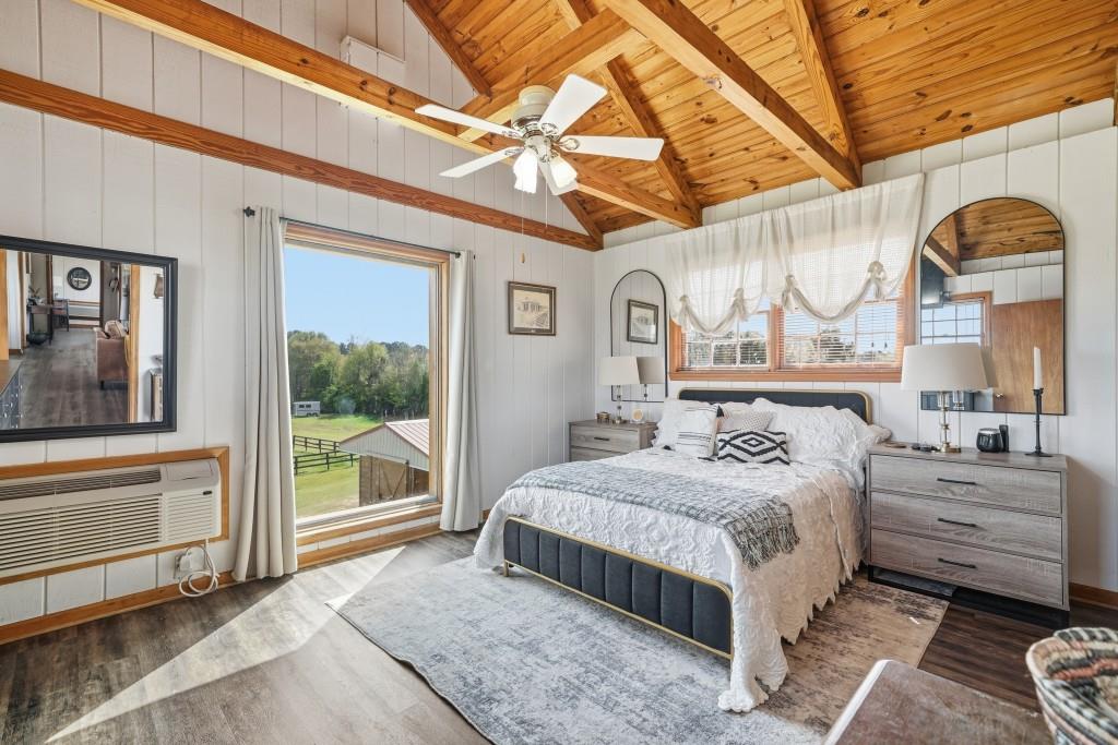 398 South 6th St Extension Milner, GA 30257 - Photo 22 of 30 a bedroom with a bed a window and painting on the wall
