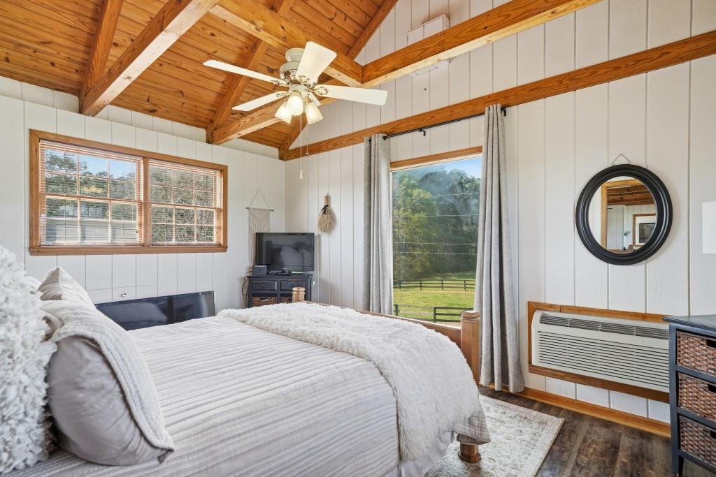 398 South 6th St Extension Milner, GA 30257 - Photo 23 of 30 a bedroom with a bed a mirror next to a window