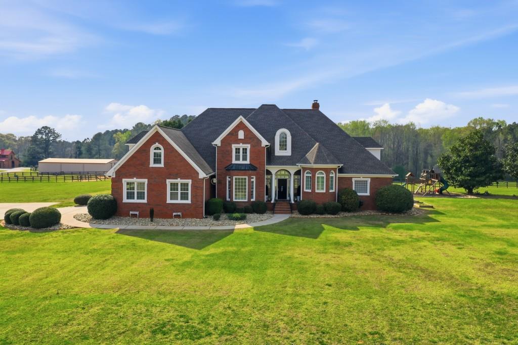398 South 6th St Extension Milner, GA 30257 - Photo 3 of 30 a front view of house with yard and green space