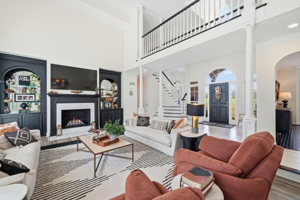 398 South 6th St Extension Milner, GA 30257 - Photo 5 of 30 a living room with furniture a fireplace and a flat screen tv