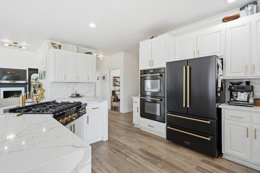 398 South 6th St Extension Milner, GA 30257 - Photo 7 of 30 a kitchen with a refrigerator and a stove top oven