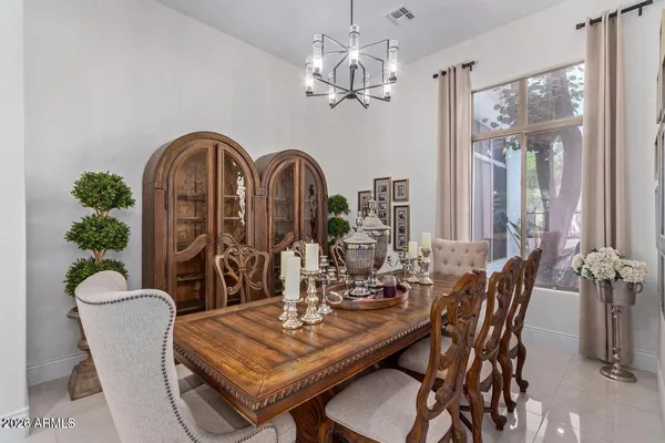 a view of a dining room with furniture and chandelier