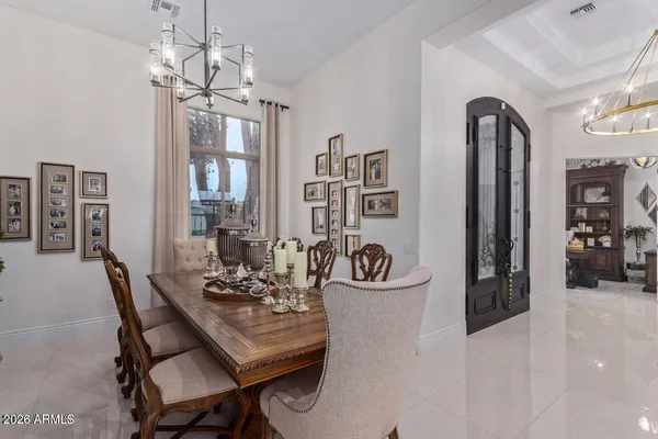 a view of a dining room with furniture and chandelier