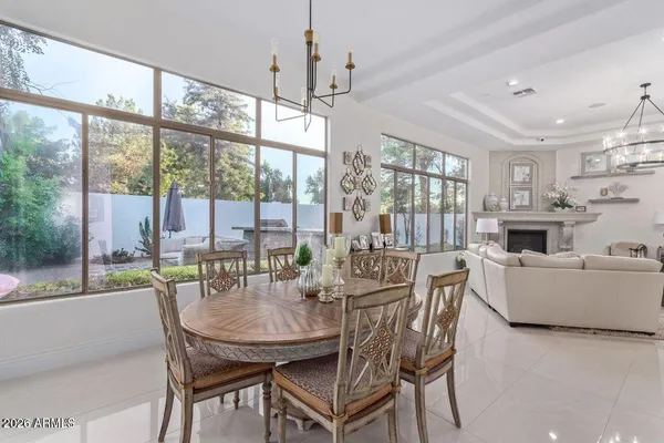 a dining room with furniture a chandelier and fireplace