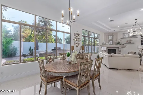 a view of a dining room with furniture a chandelier and wooden floor