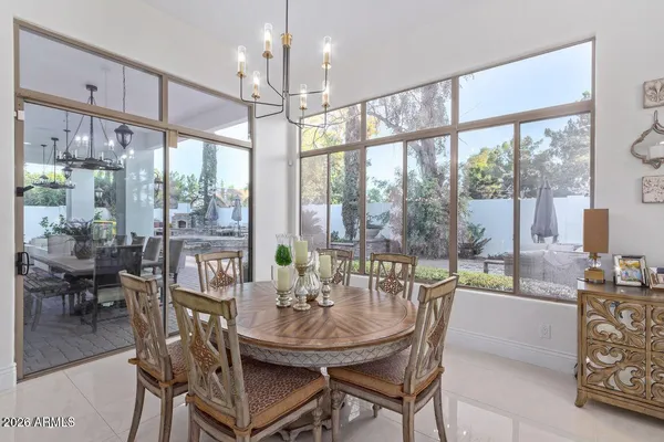 a view of a dining room with furniture large windows and wooden floor