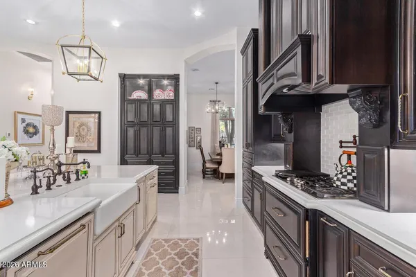 a kitchen with stainless steel appliances kitchen island granite countertop a stove and a sink