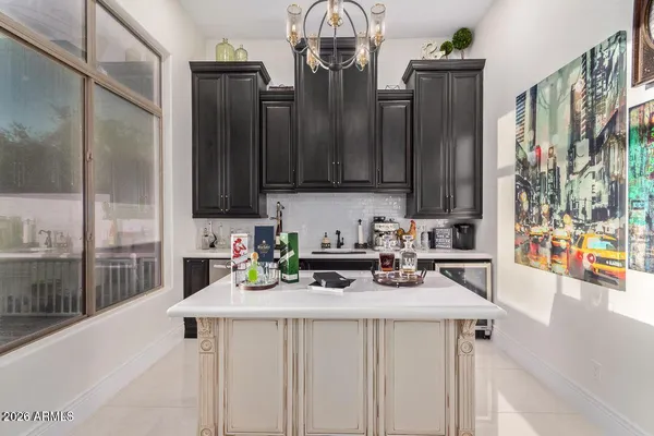 a kitchen with stainless steel appliances a sink a stove cabinets and a counter top space
