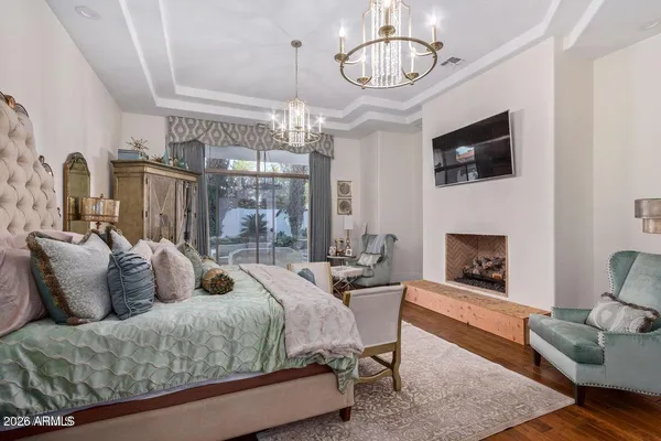 a living room with furniture chandelier and fireplace