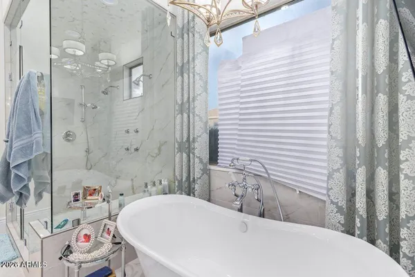 a bathroom with a bathtub and shower