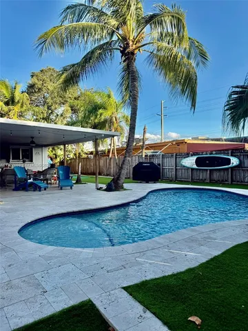 a view of swimming pool with outdoor seating and plants