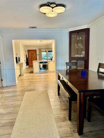 a living room with furniture a rug and a large window