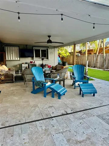 a living room with furniture a flat screen tv and a large window