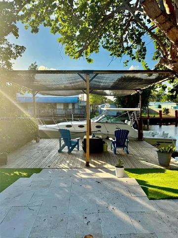 a view of a swimming pool with outdoor seating