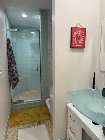 a bathroom with a shower and a sink