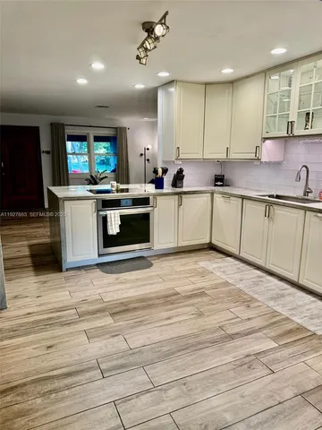 a kitchen with stainless steel appliances kitchen island granite countertop a sink and cabinets