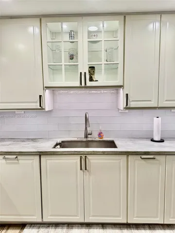 a kitchen with stainless steel appliances granite countertop a sink and cabinets