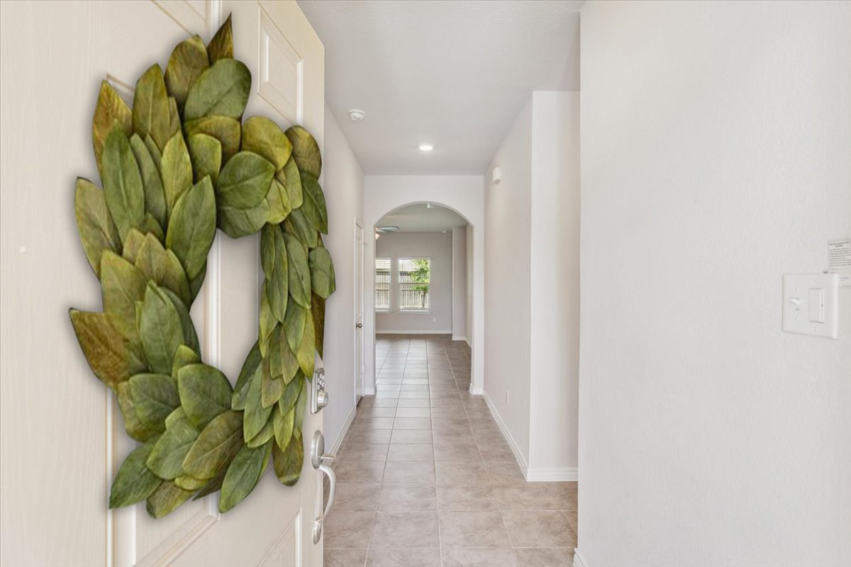 5830 Copano Road Belton, TX 76513 - Photo 7 of 34 Hallway featuring light tile patterned floors, baseboards, recessed lighting, and arched walkways