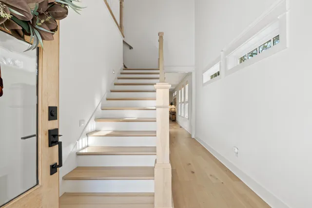 a view of a room with wooden floor and iron stairs