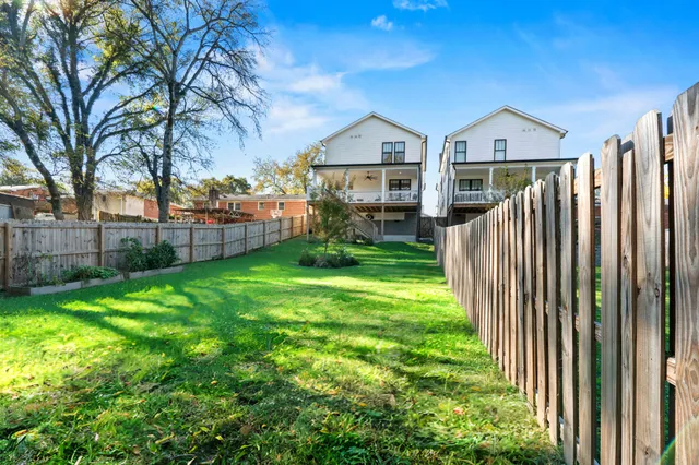 a bathroom with a double vanity sink toilet mirror and shower