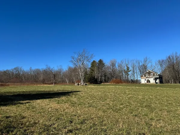 a view of a lake with trees in the background