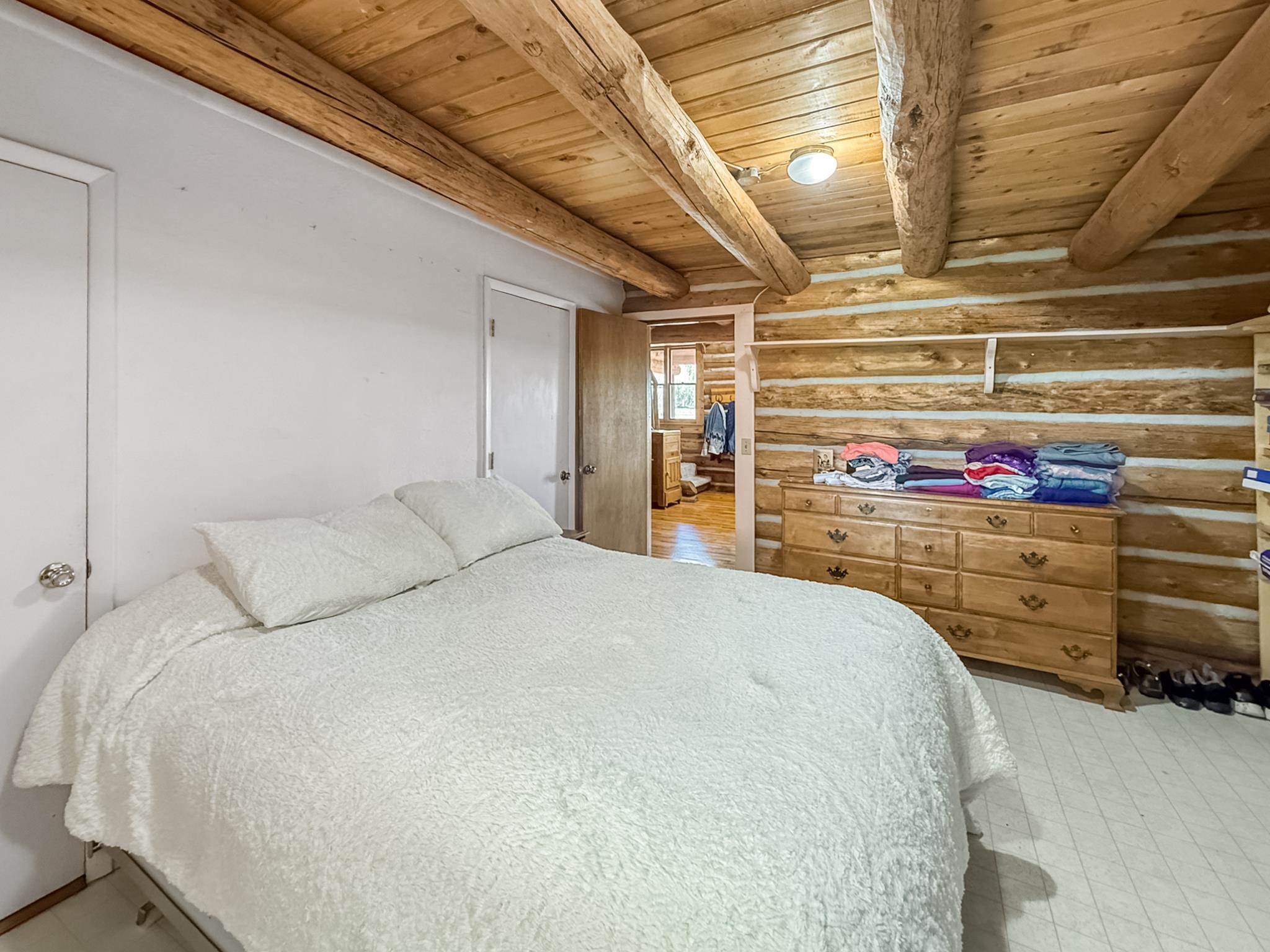 9709 3605 Road Hotchkiss, CO 81419 - Photo 27 of 42 a bedroom with a bed and a cabinet