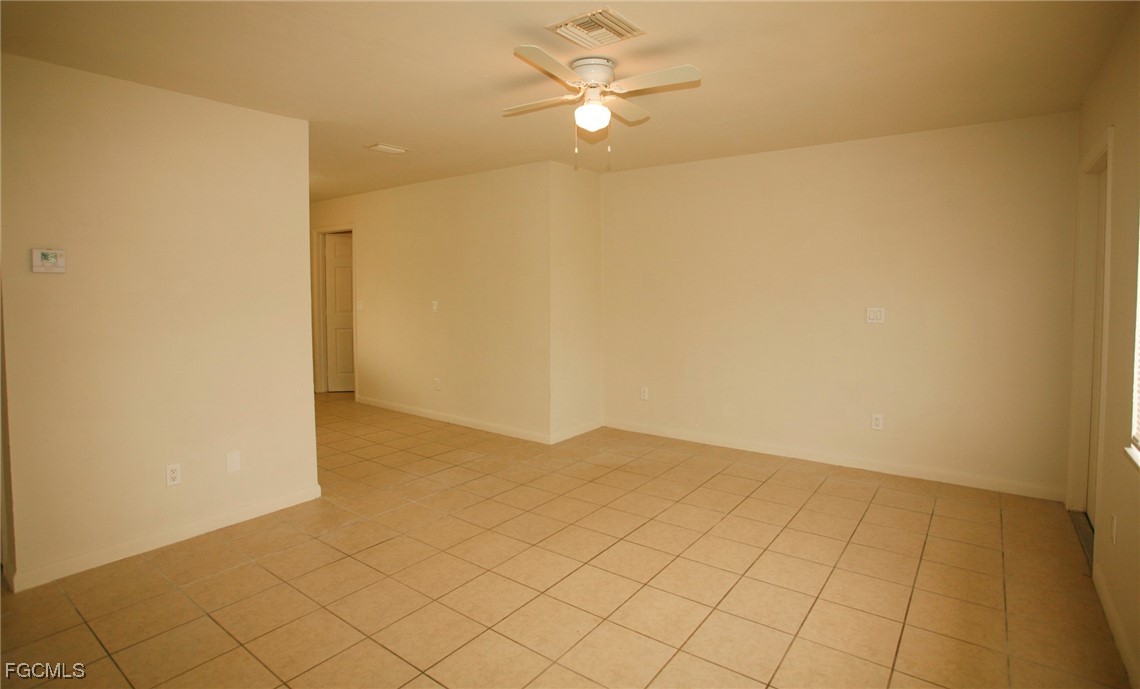 122 Gordon Avenue South Lehigh Acres, FL 33973 - Photo 3 of 12 a view of an empty room and chandelier fan