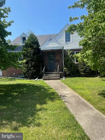 a front view of house with yard and outdoor seating