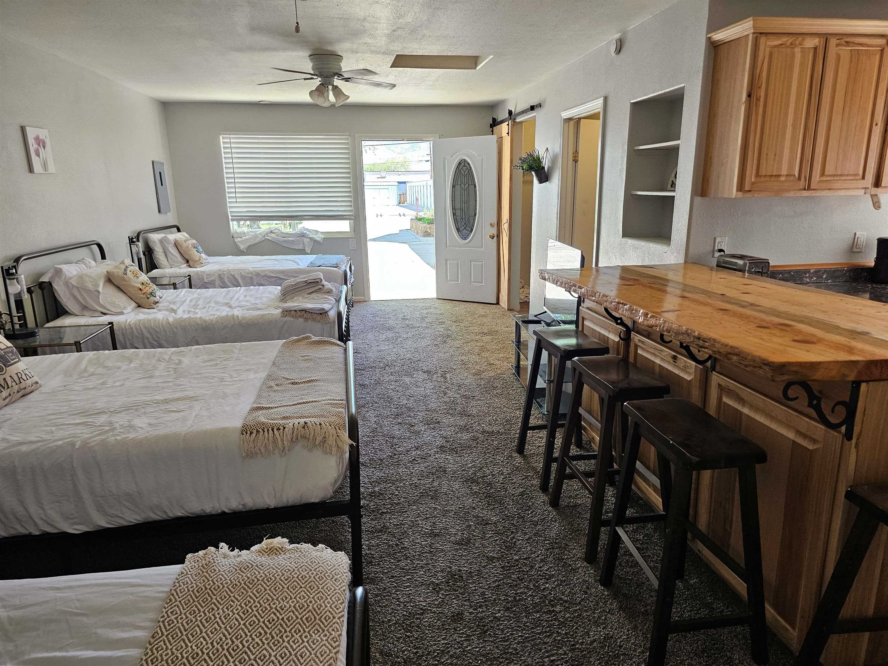 331 South Warren Street Bishop, CA 93514 - Photo 19 of 22 a living room with furniture a chandelier and a window
