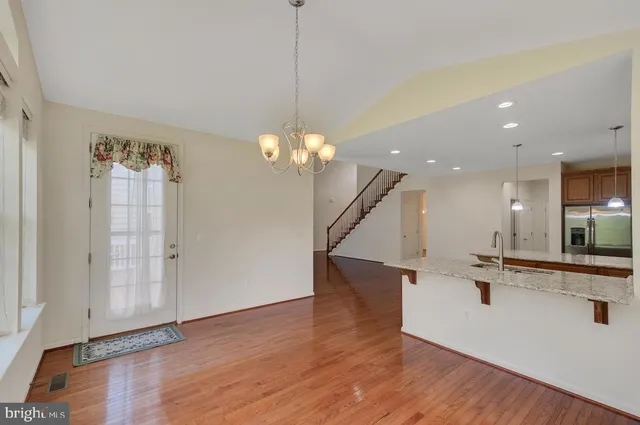 a view of a room with wooden floor and staircase