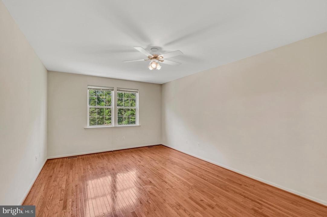 18776 Pier Trail Drive Triangle, VA 22172 - Photo 11 of 32 wooden floor in an empty room with a window